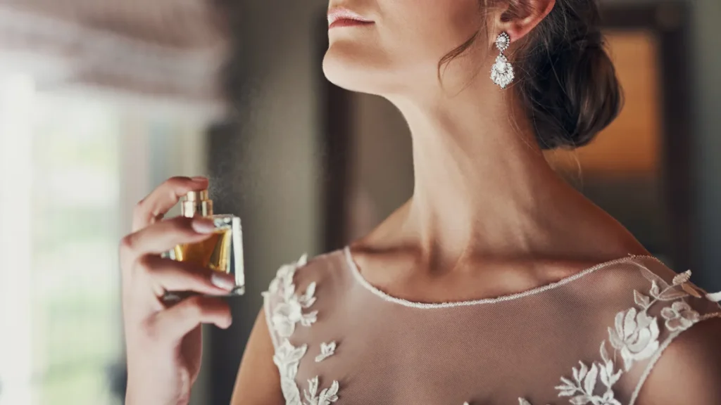 a women spray perfume on her neck